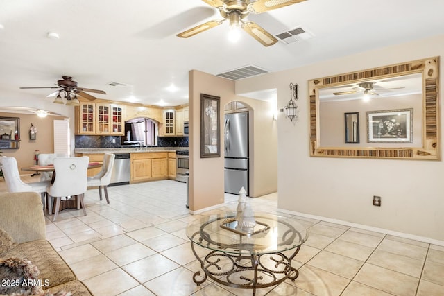 living room featuring sink and light tile patterned floors