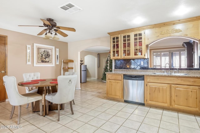 kitchen featuring dishwasher, decorative backsplash, sink, light brown cabinetry, and ceiling fan