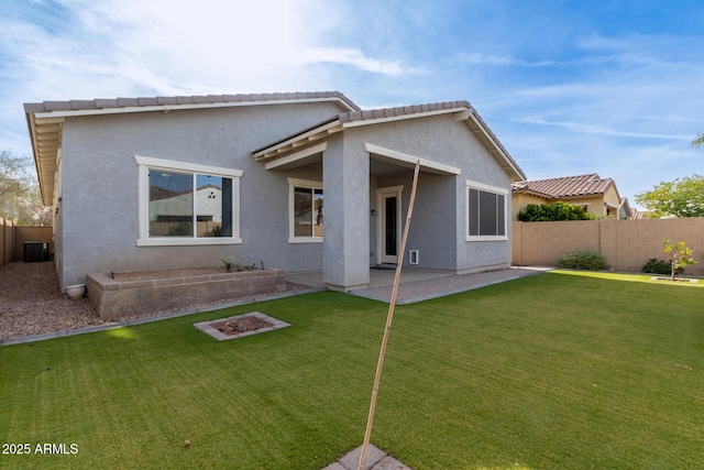 rear view of house featuring a patio area and a lawn