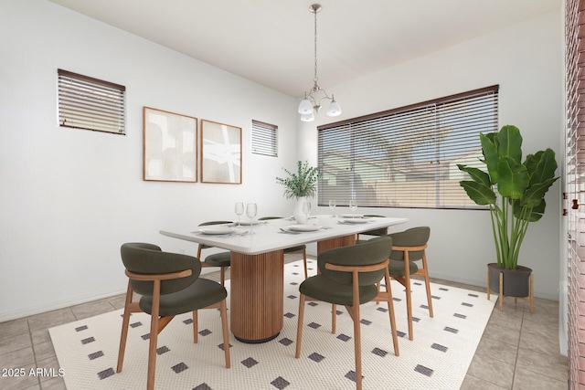 tiled dining space with an inviting chandelier