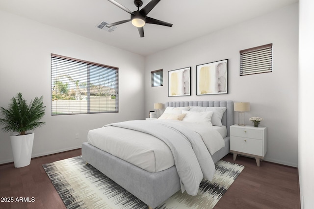 bedroom with dark hardwood / wood-style flooring and ceiling fan