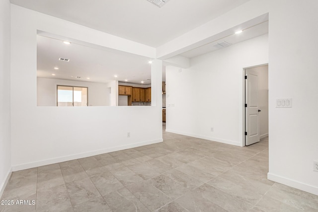 empty room featuring recessed lighting and baseboards