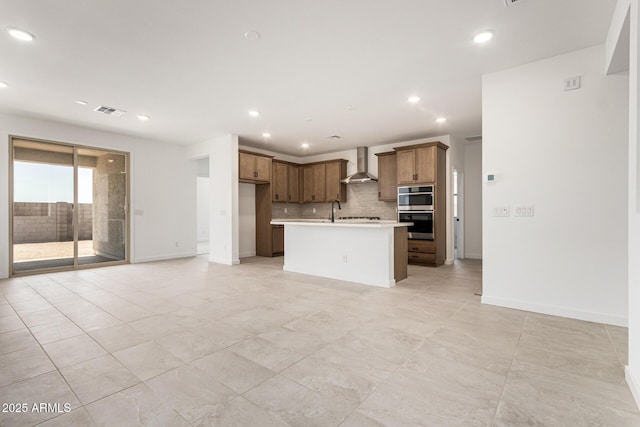 kitchen featuring wall chimney exhaust hood, stainless steel double oven, open floor plan, decorative backsplash, and recessed lighting