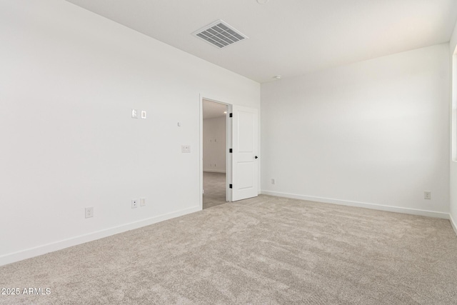 spare room featuring carpet floors and baseboards