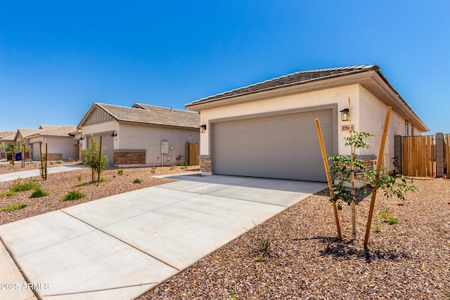 ranch-style home featuring stucco siding, driveway, a garage, and a tile roof