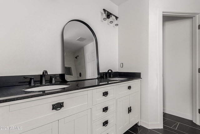 11474 N 79th Dr, Peoria, AZ 85345 - bathroom featuring double vanity, a shower, and baseboards