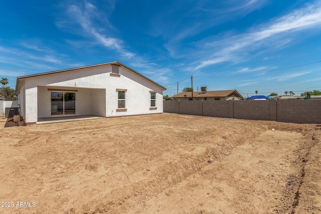 11474 N 79th Dr, Peoria, AZ 85345 - rear view of house with stucco siding, a fenced backyard, central AC unit, and a patio
