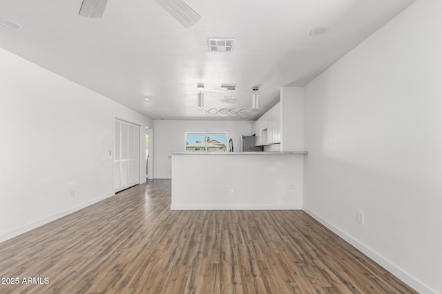 11474 N 79th Dr, Peoria, AZ 85345 - unfurnished living room with wood finished floors and baseboards
