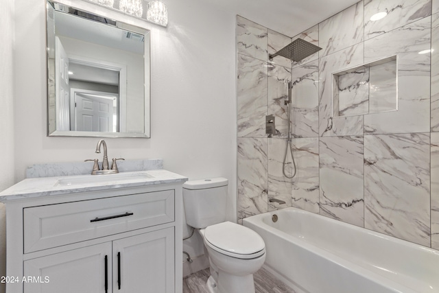 full bathroom with hardwood / wood-style flooring, vanity, toilet, and tiled shower / bath combo