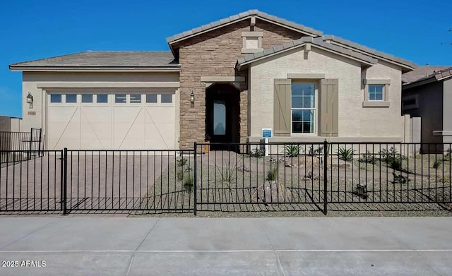 16342 W Jackson St, Goodyear, AZ 85338 - view of front facade with a fenced front yard, a garage, stucco siding, driveway, and stone siding