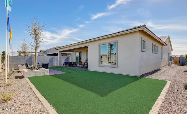 16342 W Jackson St, Goodyear, AZ 85338 - back of property featuring a fenced backyard, a patio, ceiling fan, and stucco siding
