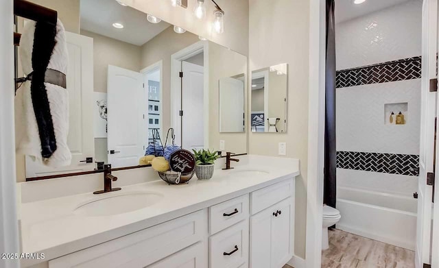 16342 W Jackson St, Goodyear, AZ 85338 - full bath with double vanity, shower / bath combo with shower curtain, and wood finished floors