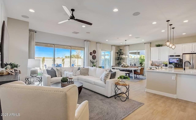 16342 W Jackson St, Goodyear, AZ 85338 - living area with plenty of natural light, ceiling fan, recessed lighting, and light wood-style flooring