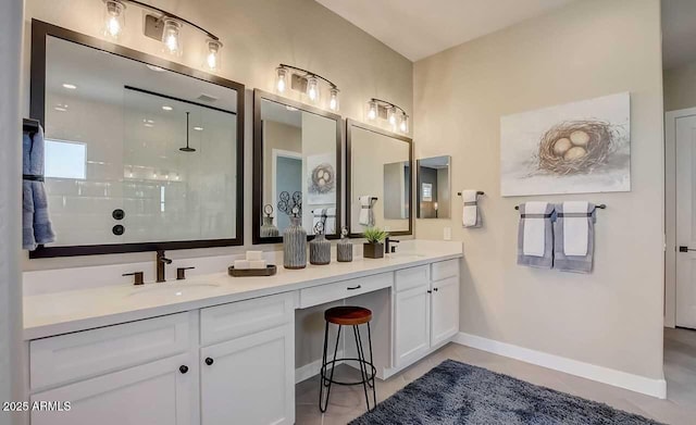 16342 W Jackson St, Goodyear, AZ 85338 - bathroom featuring double vanity, a walk in shower, and tile patterned floors