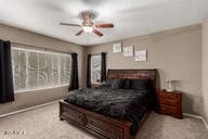 bedroom with ceiling fan and light colored carpet