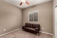 sitting room featuring light carpet and ceiling fan