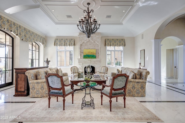 living room featuring a notable chandelier, a raised ceiling, ornamental molding, and plenty of natural light