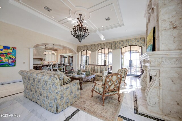 living room featuring coffered ceiling, ornamental molding, and a chandelier