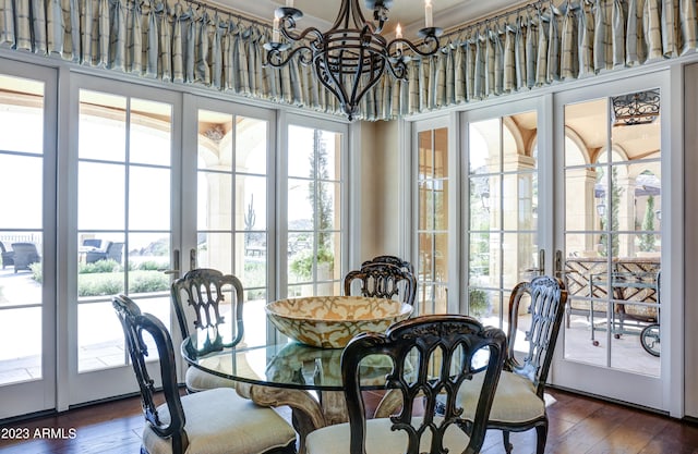 dining room featuring french doors, a notable chandelier, dark wood-type flooring, and a high ceiling