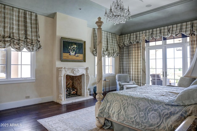 bedroom with multiple windows, crown molding, dark wood-type flooring, and a premium fireplace