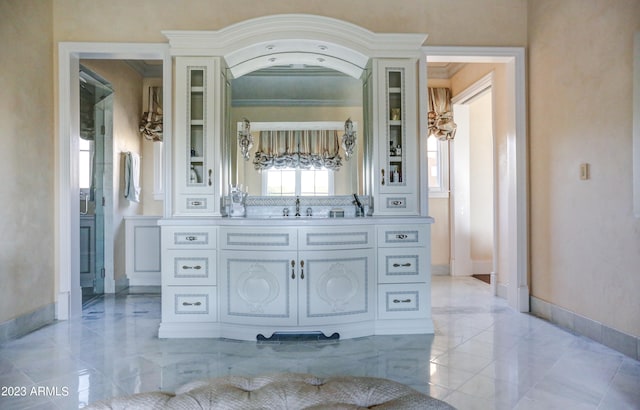 bathroom featuring vanity and ornamental molding