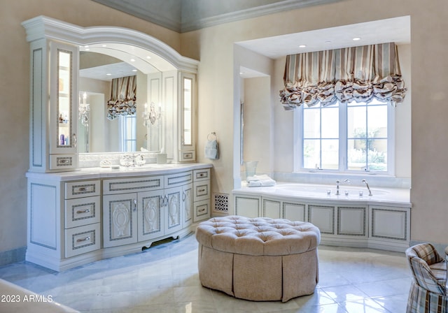 bathroom featuring tile patterned floors, vanity, crown molding, and a tub