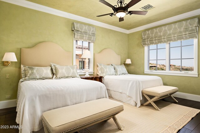 bedroom featuring ceiling fan, dark hardwood / wood-style floors, and crown molding