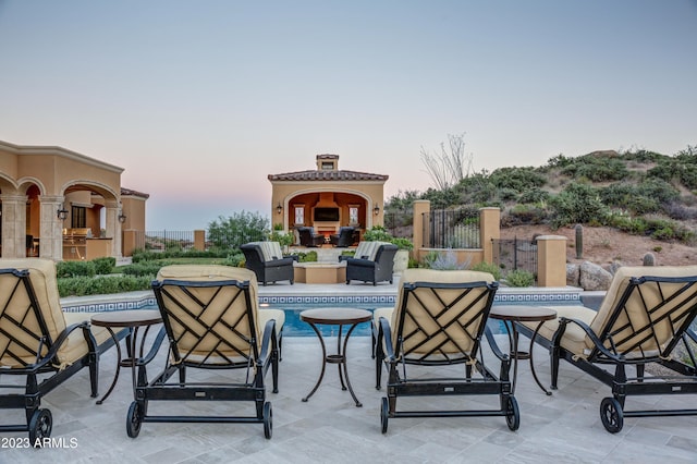 view of patio terrace at dusk