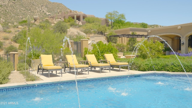 view of pool with a mountain view and a patio area