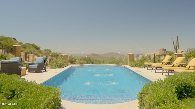 view of pool featuring a patio and a mountain view