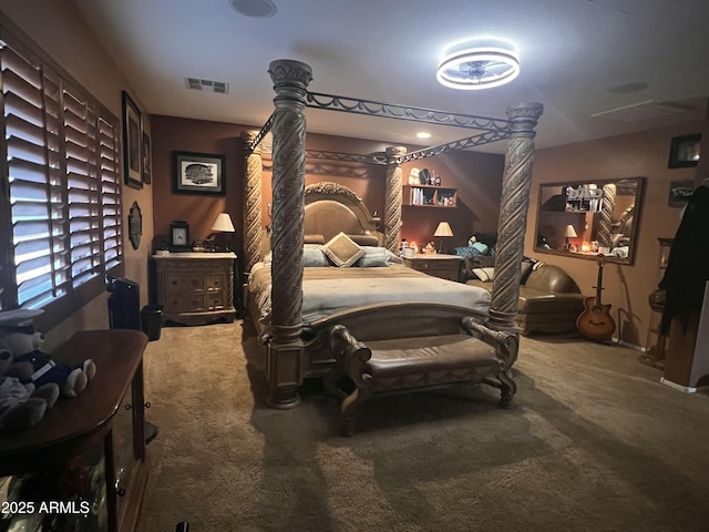 bedroom with decorative columns and carpet flooring