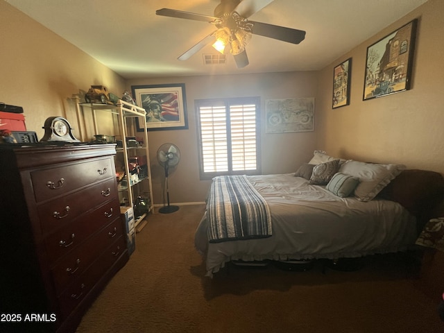 bedroom with ceiling fan and dark colored carpet