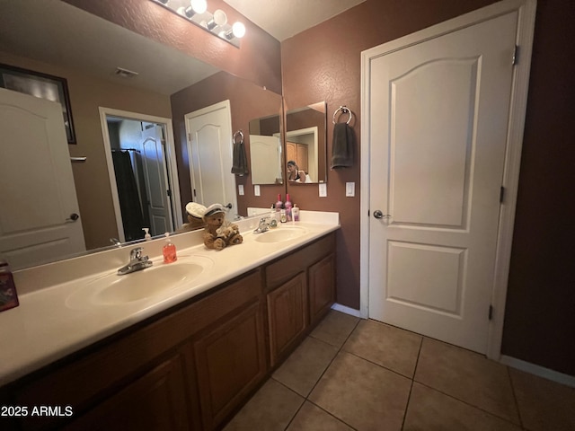 bathroom with tile patterned floors and vanity