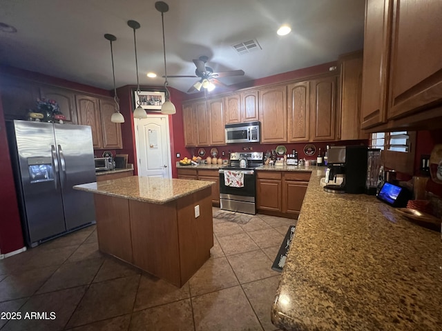 kitchen with light tile patterned flooring, a kitchen island, pendant lighting, ceiling fan, and stainless steel appliances