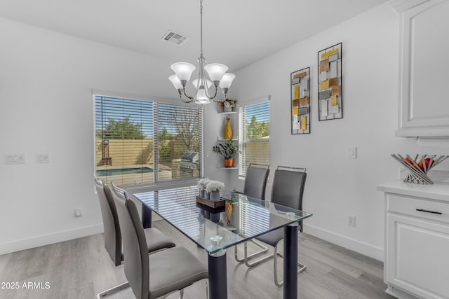 dining room with visible vents, baseboards, light wood-type flooring, and a notable chandelier