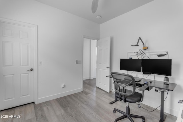 office area with wood finished floors, baseboards, and a ceiling fan