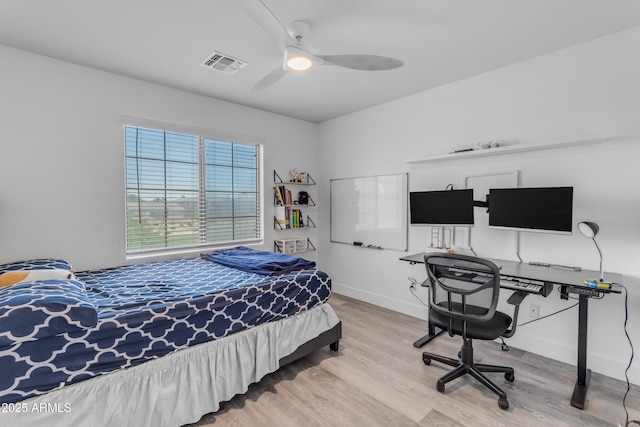 bedroom with visible vents, baseboards, a ceiling fan, and wood finished floors