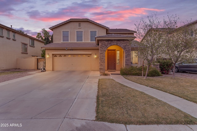 view of front of home featuring stucco siding, driveway, stone siding, an attached garage, and a tile roof