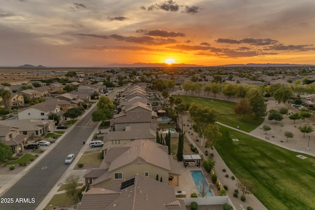 aerial view at dusk featuring a residential view