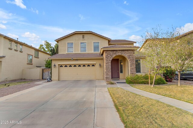 traditional-style house featuring stucco siding, driveway, stone siding, an attached garage, and a tiled roof