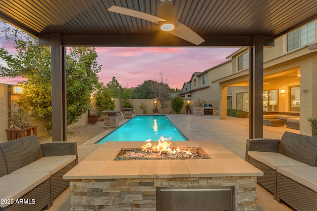 view of swimming pool featuring a patio area, an outdoor living space with a fire pit, a fenced backyard, and a fenced in pool