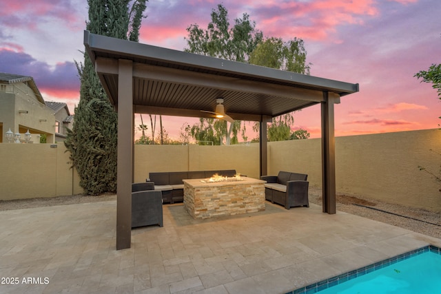 view of patio / terrace featuring a fenced in pool, a fenced backyard, and an outdoor living space with a fire pit