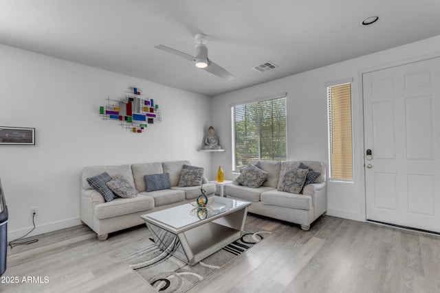 living area with ceiling fan, visible vents, baseboards, and light wood-style flooring