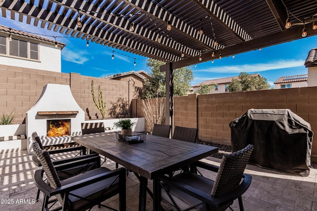 view of patio / terrace with an outdoor brick fireplace, area for grilling, fence, outdoor dining area, and a pergola