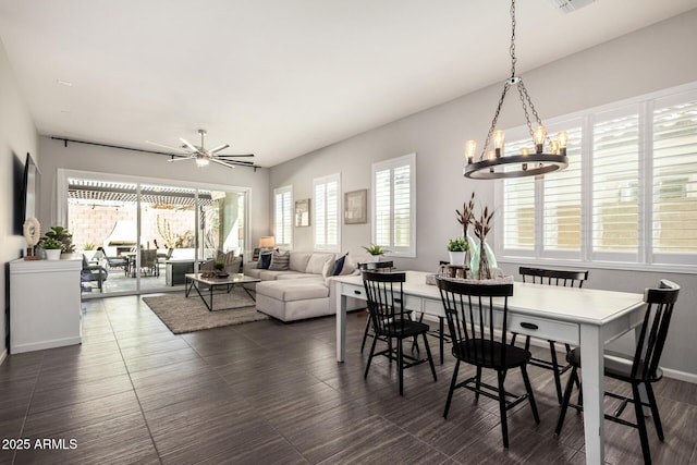 dining room with a healthy amount of sunlight, visible vents, and ceiling fan with notable chandelier