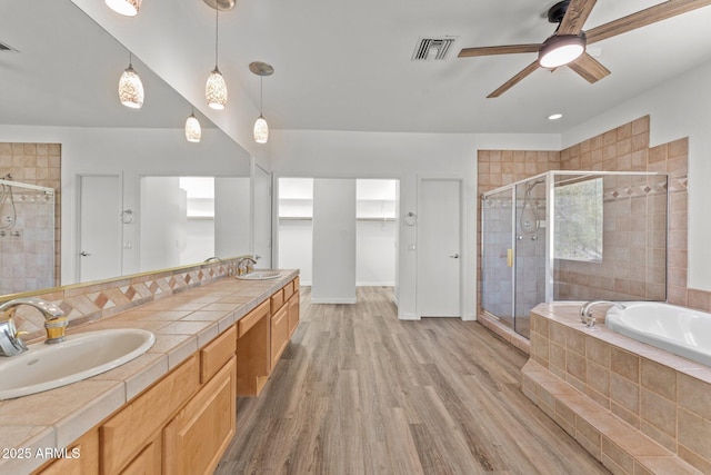 31234 N 47th Pl, Cave Creek, AZ 85331 - bathroom featuring a stall shower, double vanity, ceiling fan, a garden tub, and wood finished floors