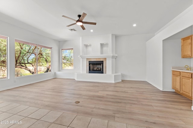 31234 N 47th Pl, Cave Creek, AZ 85331 - unfurnished living room with light wood-style flooring, ceiling fan, a tile fireplace, and recessed lighting