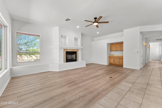 31234 N 47th Pl, Cave Creek, AZ 85331 - unfurnished living room with a ceiling fan, light wood-type flooring, a tiled fireplace, and recessed lighting