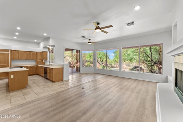 31234 N 47th Pl, Cave Creek, AZ 85331 - kitchen with dishwashing machine, a high end fireplace, light countertops, open floor plan, and ceiling fan