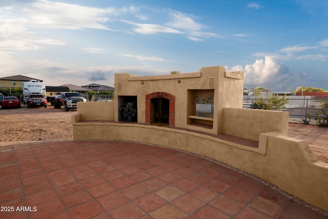 19519 W Minnezona Ave, Litchfield Park, AZ 85340 - view of patio featuring a residential view, a fireplace, and fence